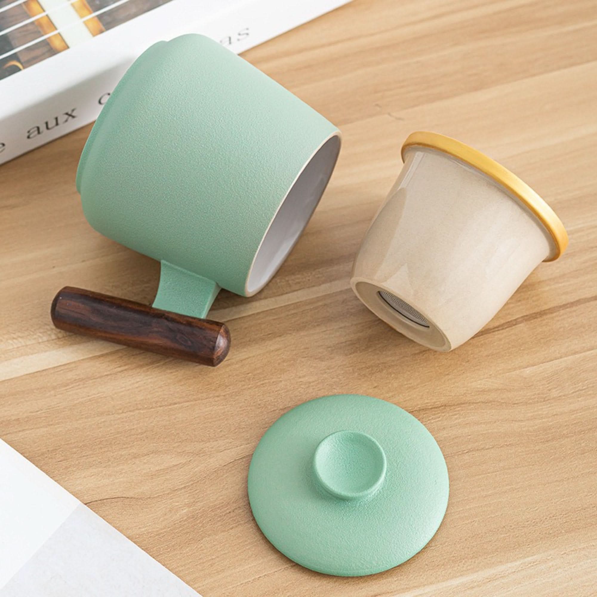 Minimalist Japanese Mug: green ceramic, wood handle, tea strainer, lid.